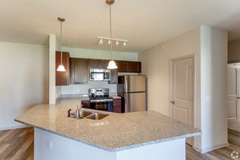 A kitchen with granite countertops and stainless steel appliances